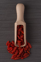 Image showing Wooden scoop with dry red goji berries