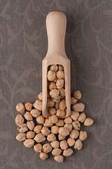 Image showing Wooden scoop with chickpeas