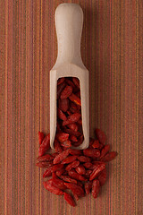 Image showing Wooden scoop with dry red goji berries