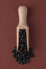 Image showing Wooden scoop with black beans