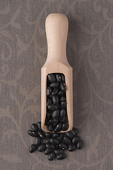 Image showing Wooden scoop with black beans