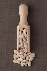 Image showing Wooden scoop with white beans