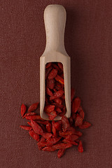 Image showing Wooden scoop with dry red goji berries