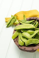 Image showing Snow peas on wooden bowl