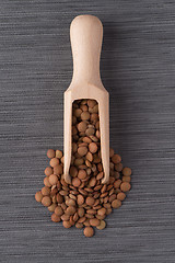 Image showing Wooden scoop with lentils