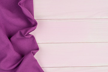 Image showing Purple towel over wooden table