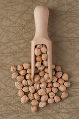 Image showing Wooden scoop with chickpeas