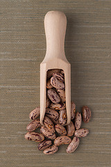 Image showing Wooden scoop with pinto beans