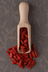 Image showing Wooden scoop with dry red goji berries