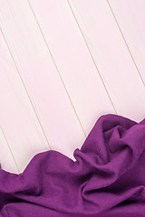 Image showing Purple towel over wooden table