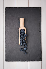 Image showing Blueberries on a wooden spoon