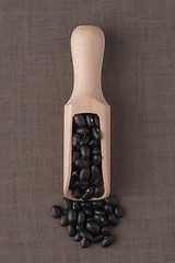 Image showing Wooden scoop with black beans