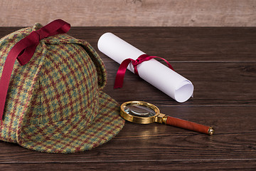 Image showing Wrapped paper sheets and magnifying glass