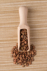 Image showing Wooden scoop with lentils