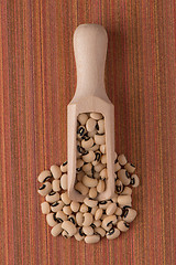 Image showing Wooden scoop with white beans