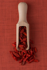 Image showing Wooden scoop with dry red goji berries