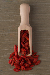 Image showing Wooden scoop with dry red goji berries