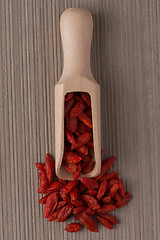 Image showing Wooden scoop with dry red goji berries