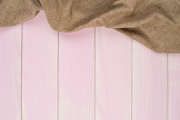 Image showing Beige towel over wooden table