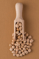 Image showing Wooden scoop with chickpeas