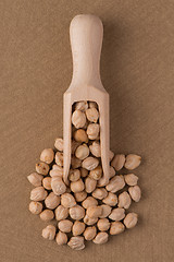 Image showing Wooden scoop with chickpeas