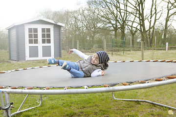 Image showing Boy jumping on trampoline