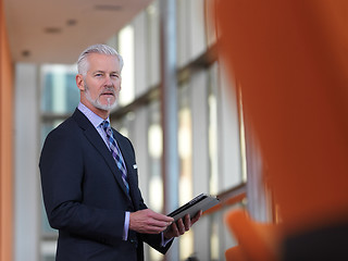 Image showing senior business man working on tablet computer