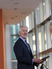 Image showing senior business man working on tablet computer