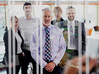 Image showing senior business man with his team at office