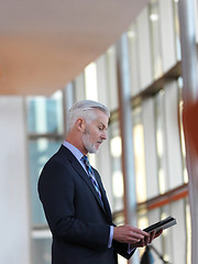 Image showing senior business man working on tablet computer