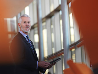 Image showing senior business man working on tablet computer