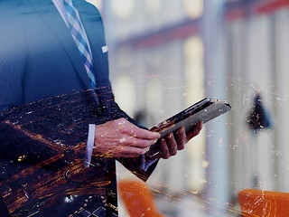 Image showing senior business man working on tablet computer