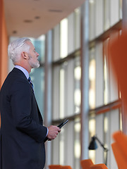 Image showing senior business man working on tablet computer