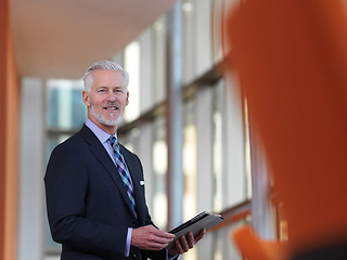 Image showing senior business man working on tablet computer