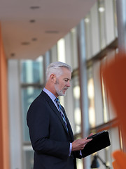 Image showing senior business man working on tablet computer