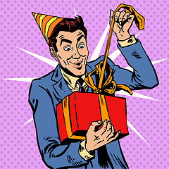 Image showing Male birthday unpacks the gift