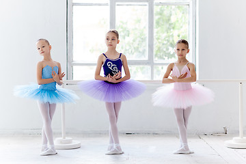 Image showing Three little ballet girls in tutu and posing together