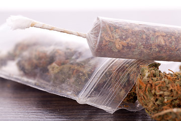 Image showing Close up of dried marijuana leaves and joint