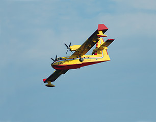 Image showing Fire fighting airplane descending for  water.