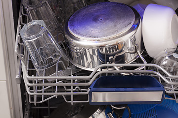 Image showing Dishwasher loades in a kitchen with clean dishes