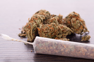 Image showing Close up of dried marijuana leaves and joint