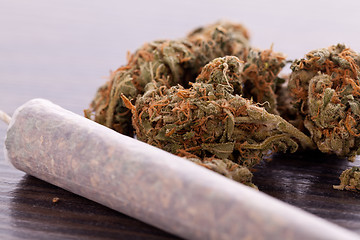 Image showing Close up of dried marijuana leaves and joint