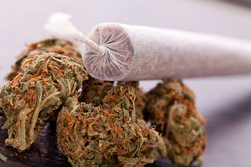 Image showing Close up of dried marijuana leaves and joint