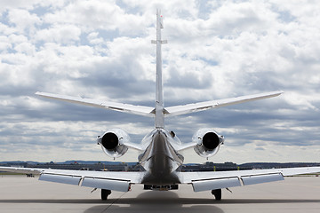 Image showing Aircraft learjet Plane in front of the Airport with cloudy sky