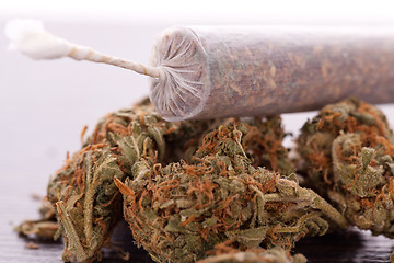 Image showing Close up of dried marijuana leaves and joint