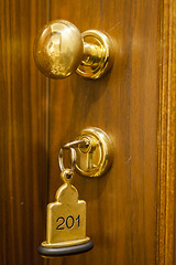 Image showing Hotel Room Key lying on Bed with keyring