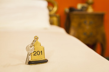 Image showing Hotel Room Key lying on Bed with keyring