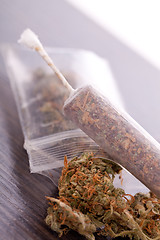 Image showing Close up of dried marijuana leaves and joint