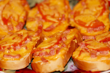 Image showing hot sandwiches with sausage and melted cheese