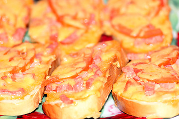 Image showing hot sandwiches with sausage and melted cheese